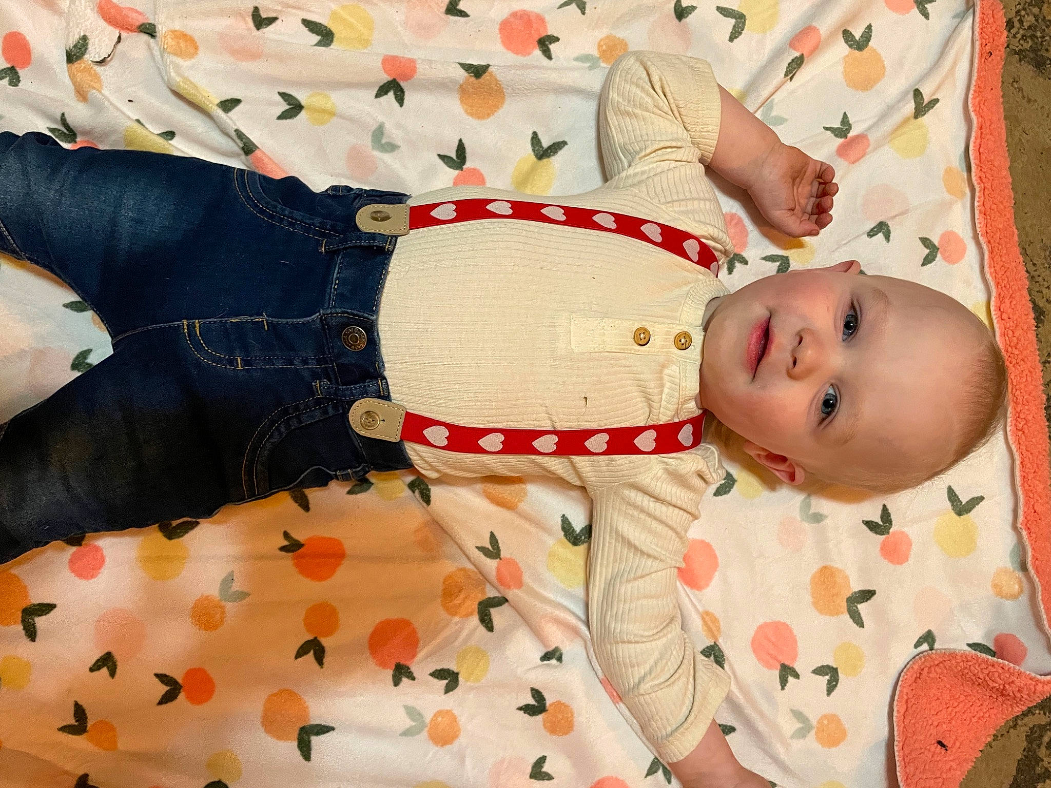 Axel is registered to the contest to win money with this photo: baby, baby_products, baby_toddler_clothing, carmine, child, comfort, fashion_accessory, linens, pattern, peach, person, room, sleeve, textile, toddler