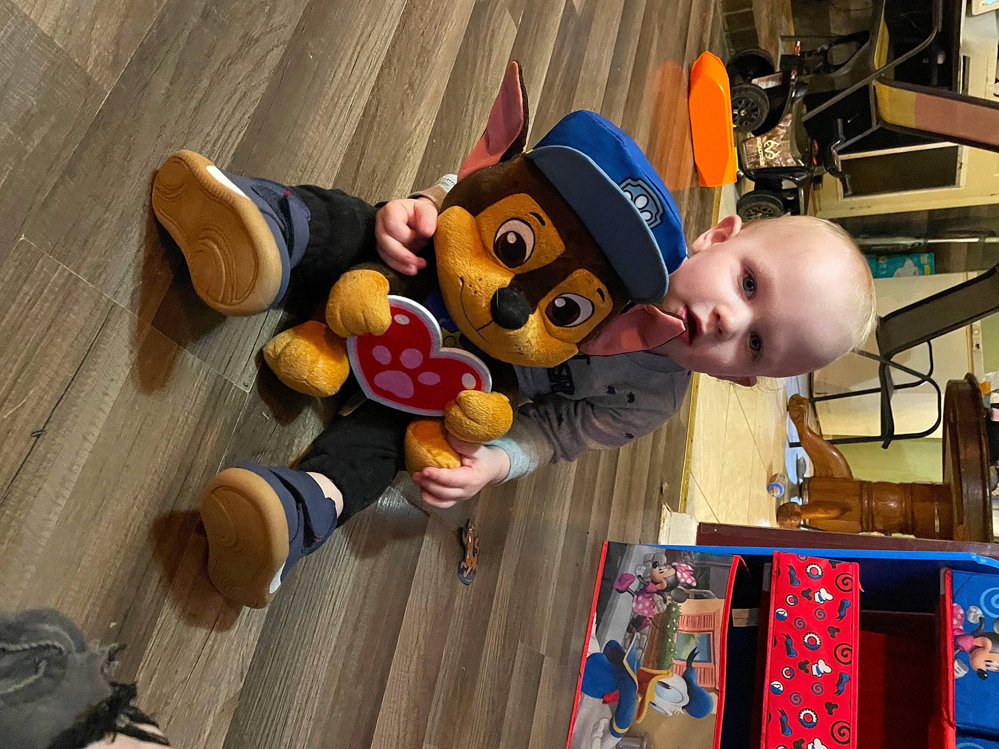 Axel joined the competition — help win amazing prizes! baby, baby_toys, child, flooring, fun, happy, hardwood, hat, leisure, person, play, recreation, room, smile, stuffed_toy, toddler, toy, vacation, wood, world