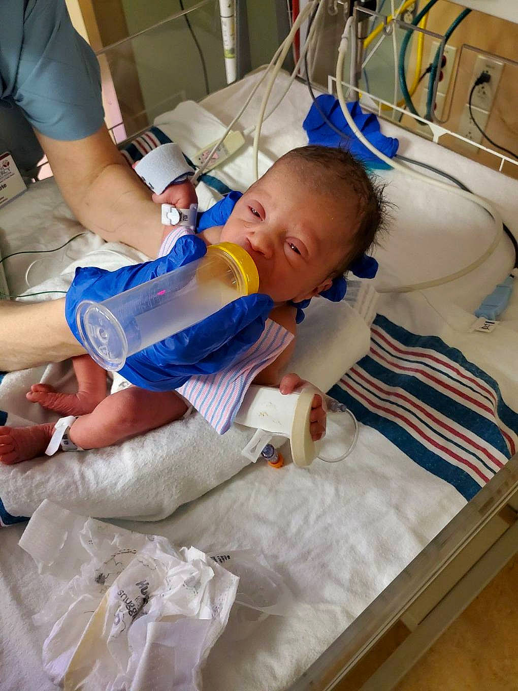 Jolene is registered to the contest to win money with this photo: baby, baby_bottle, baby_products, bottle, drink, drinking, health_care, hospital, hospital_bed, infant_formula, medical, medical_equipment, medical_procedure, patient, person, plastic_bag, plastic_bottle, service