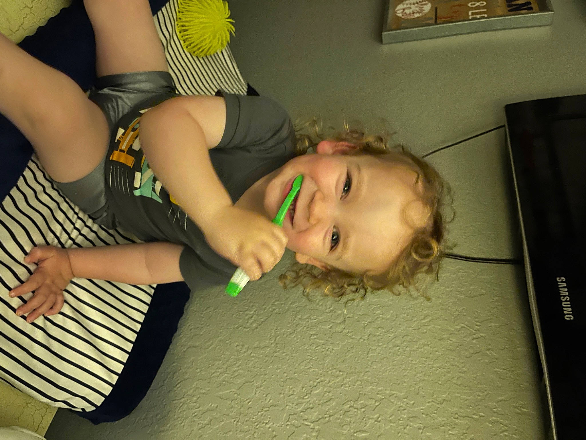 Killian is registered to the contest to win money with this photo: arm, child, dress, eye, finger, flooring, fun, gesture, hairstyle, happy, human_body, joy, leg, long_hair, mouth, person, picture_frame, smile, thigh, thumb