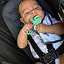 baby, infant, car_seat, teether, pacifier, baby_clothing, straps, black_straps, soft_toy, blanket, cute, child, holding, closeup, skin, face, hand, comfort, indoor, seat