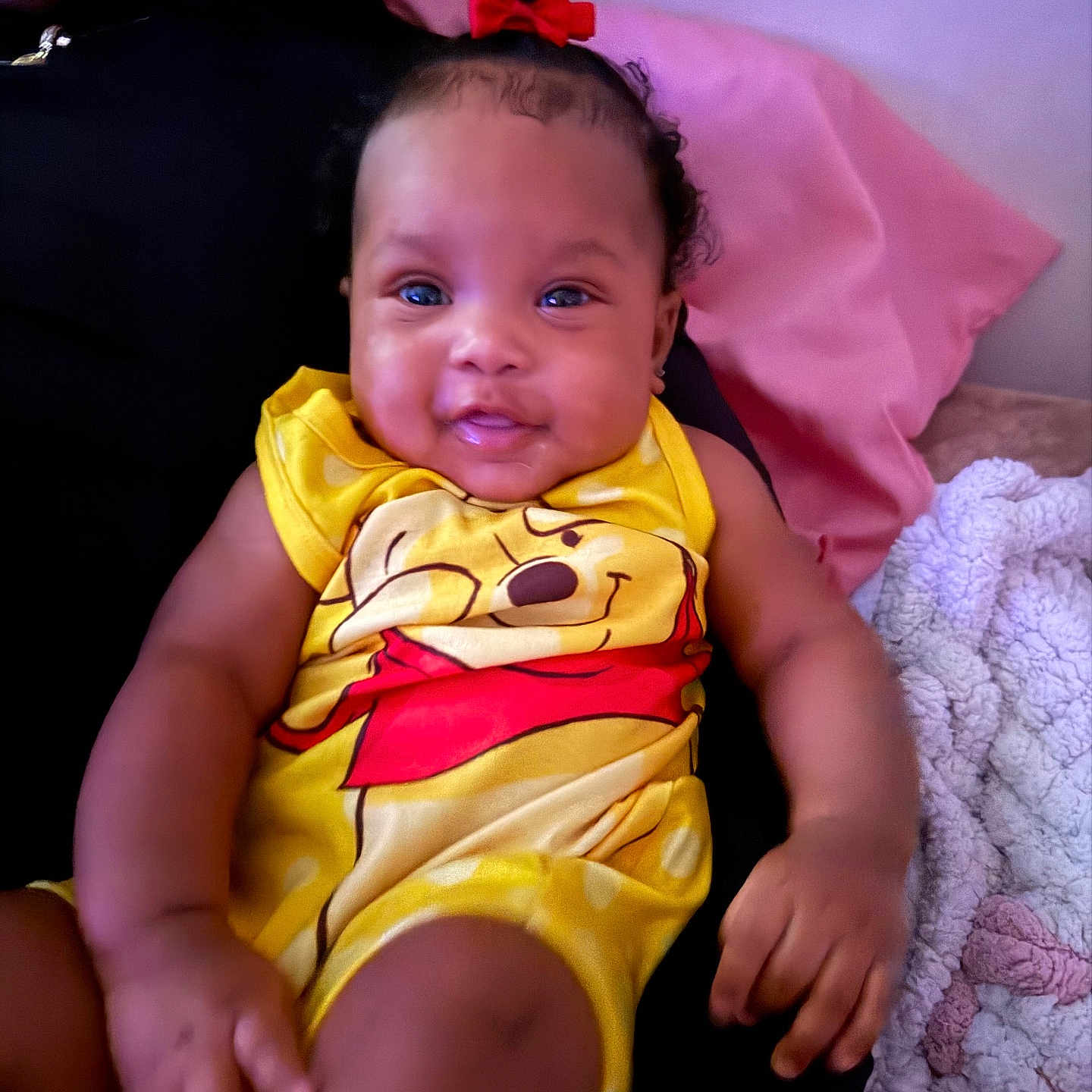 Aunesty joined the competition — help win amazing prizes! baby, child, smile, red_bow, yellow_outfit, winnie_the_pooh, sitting, person, blanket, bedding, indoor, happy, cute, portrait, infant, clothing, hand, face, head, cozy