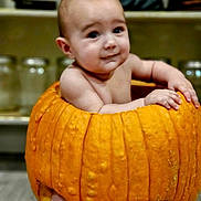 Ezekiel joined the competition — help win amazing prizes! baby, pumpkin, child, kitchen, jar, sitting, orange, cute, skin, face, expression, indoors, food, vegetable, holiday, autumn, smile, hands, legs, background