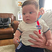 Albie joined the competition — help win amazing prizes! baby, child, person, hand, clothing, indoor, living_room, carpet, couch, photography, portrait, smile, furniture, sportswear, football, england, window, curtain, family, home