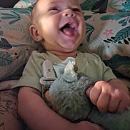 Malakai joined the competition — help win amazing prizes! baby, child, clothing, comfort, cushion, cute, expression, hand, happy, head, holding, indoors, infant, laughing, pattern, plush_toy, portrait, skin, smiling, soft_toy