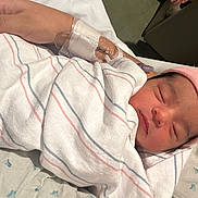 Levaeh joined the competition — help win amazing prizes! newborn, baby, hospital, blanket, pink_hat, swaddled, sleeping, hand, iv_line, medical_tape, patient_care, infant, resting, bed, healthcare, close_up, portrait, person, indoor, soft_lighting