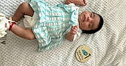 Levaeh joined the competition — help win amazing prizes! baby, child, cozy, cute, dress, indoors, infant, lying_down, milestone_marker, newborn, one_month, peaceful, portrait, resting, sleepy, small_feet, small_hand, soft_texture, striped_clothing, white_blanket