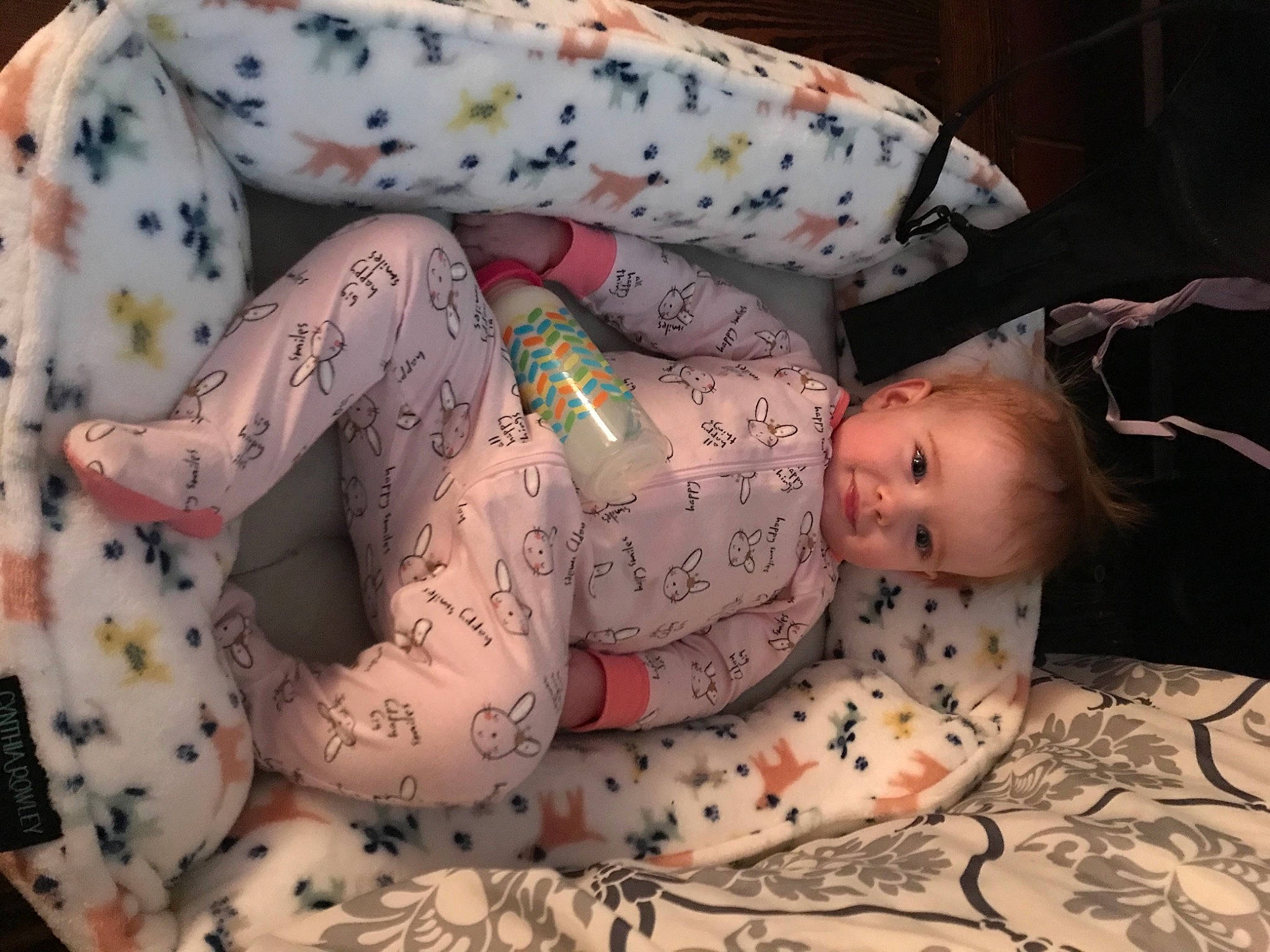 Addison is registered to the contest to win money with this photo: abdomen, arm, baby, baby_products, baby_toddler_clothing, child, comfort, finger, hand, human_body, human_leg, leg, linens, pattern, person, pink, skin, sleeve, thigh, toddler