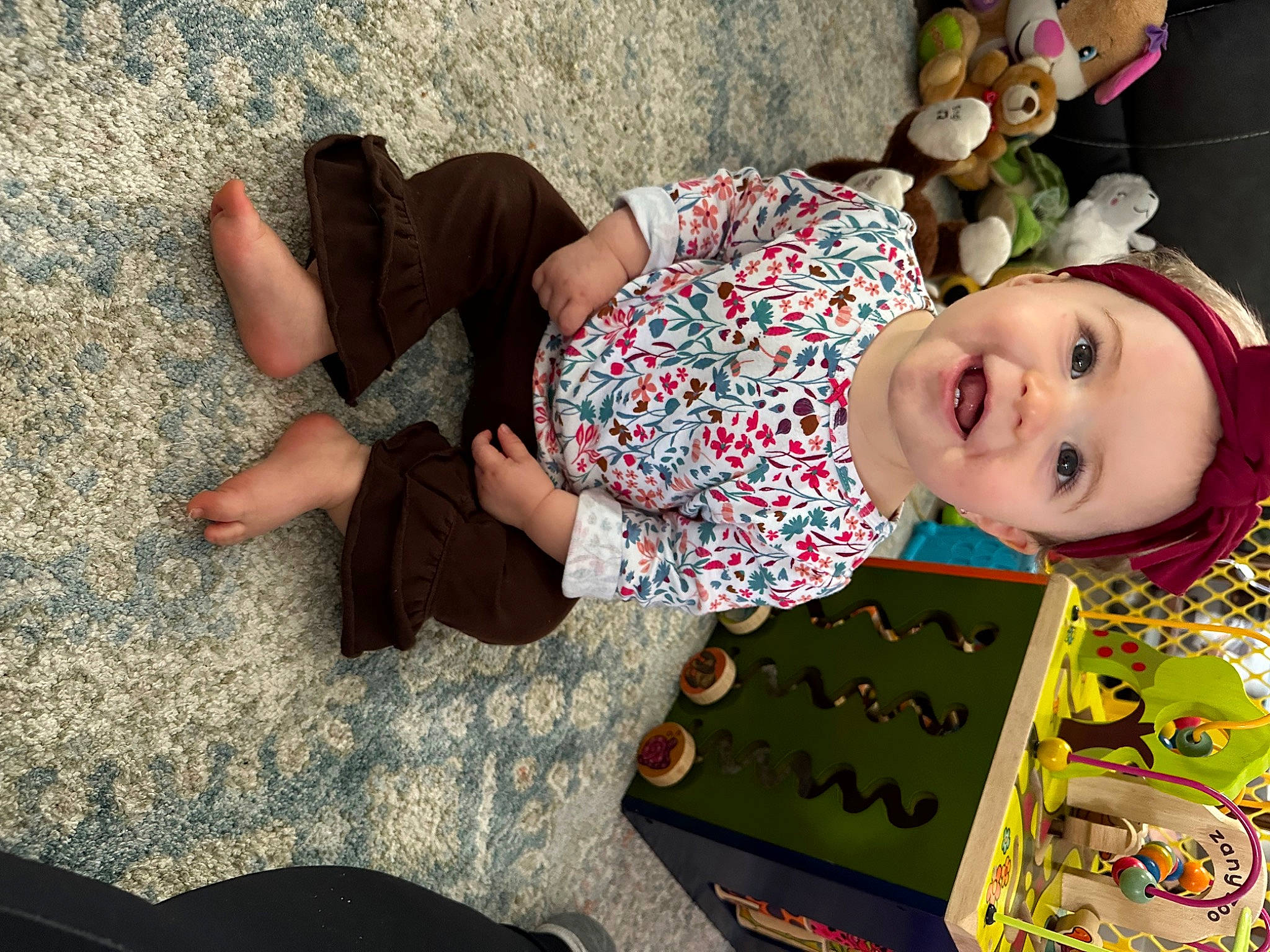 Maeve joined the competition — help win amazing prizes! baby, baby_toddler_clothing, child, comfort, flooring, foot, fun, grass, happy, headwear, human_leg, joy, lap, leisure, mammal, pattern, person, sitting, smile, textile