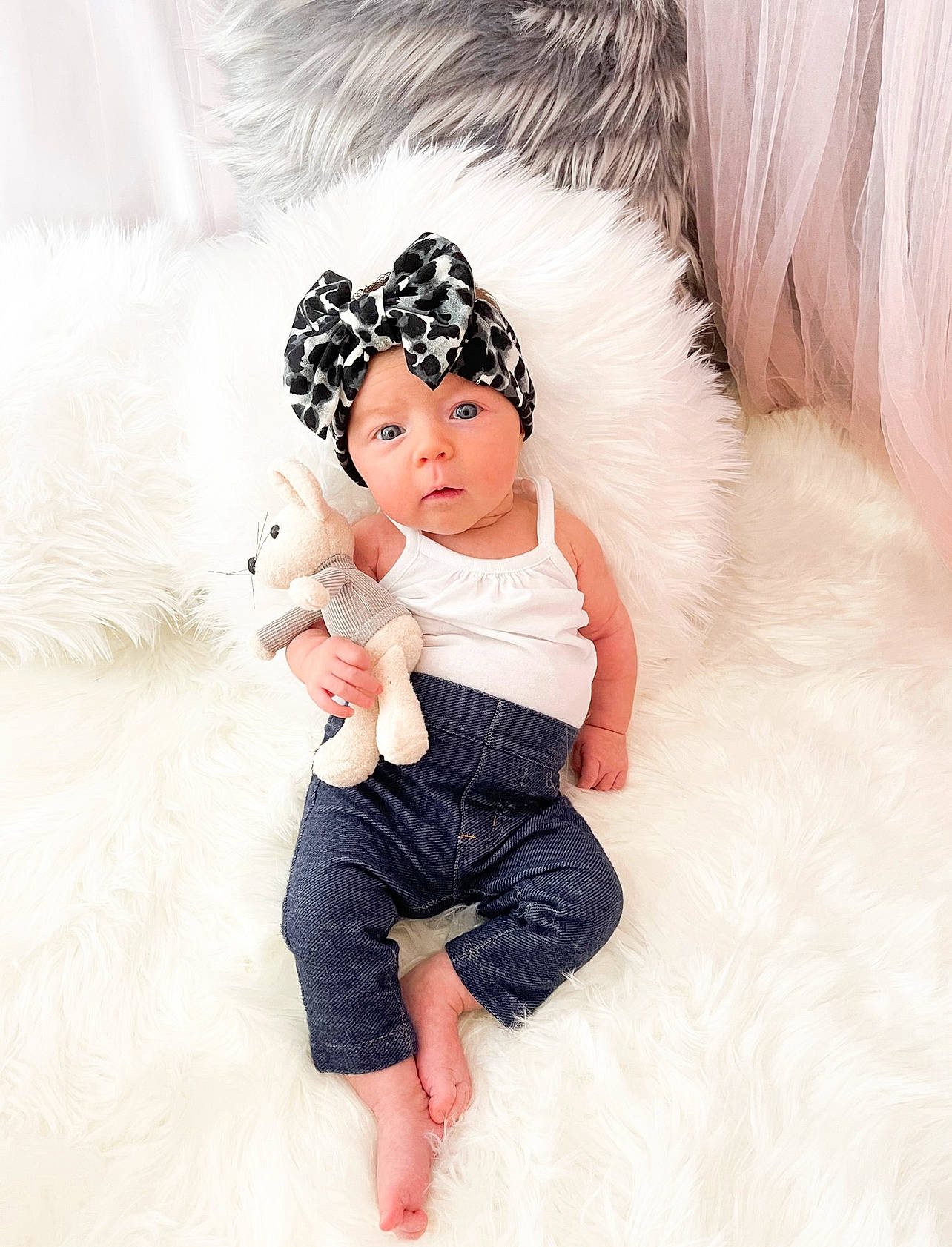 Lillian is registered to the contest to win money with this photo: baby_toddler_clothing, cap, comfort, eyelash, face, fashion_accessory, fashion_design, feather, fun, fur, gesture, hair_accessory, happy, headpiece, headwear, person, pink, sitting, skin, sleeve