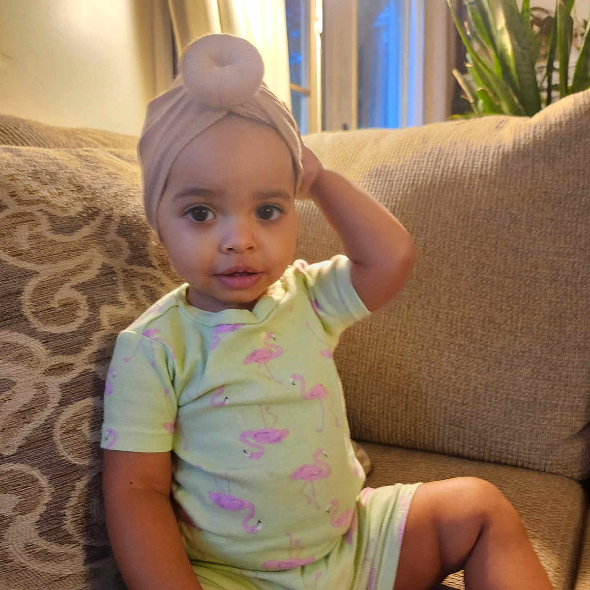 Illana-Rae joined the competition — help win amazing prizes! child, clothing, comfort, couch, curtain, face, flamingo, furniture, headwear, home, indoor, lamp, pattern, person, plant, seated, skin, smiling, toddler, turban