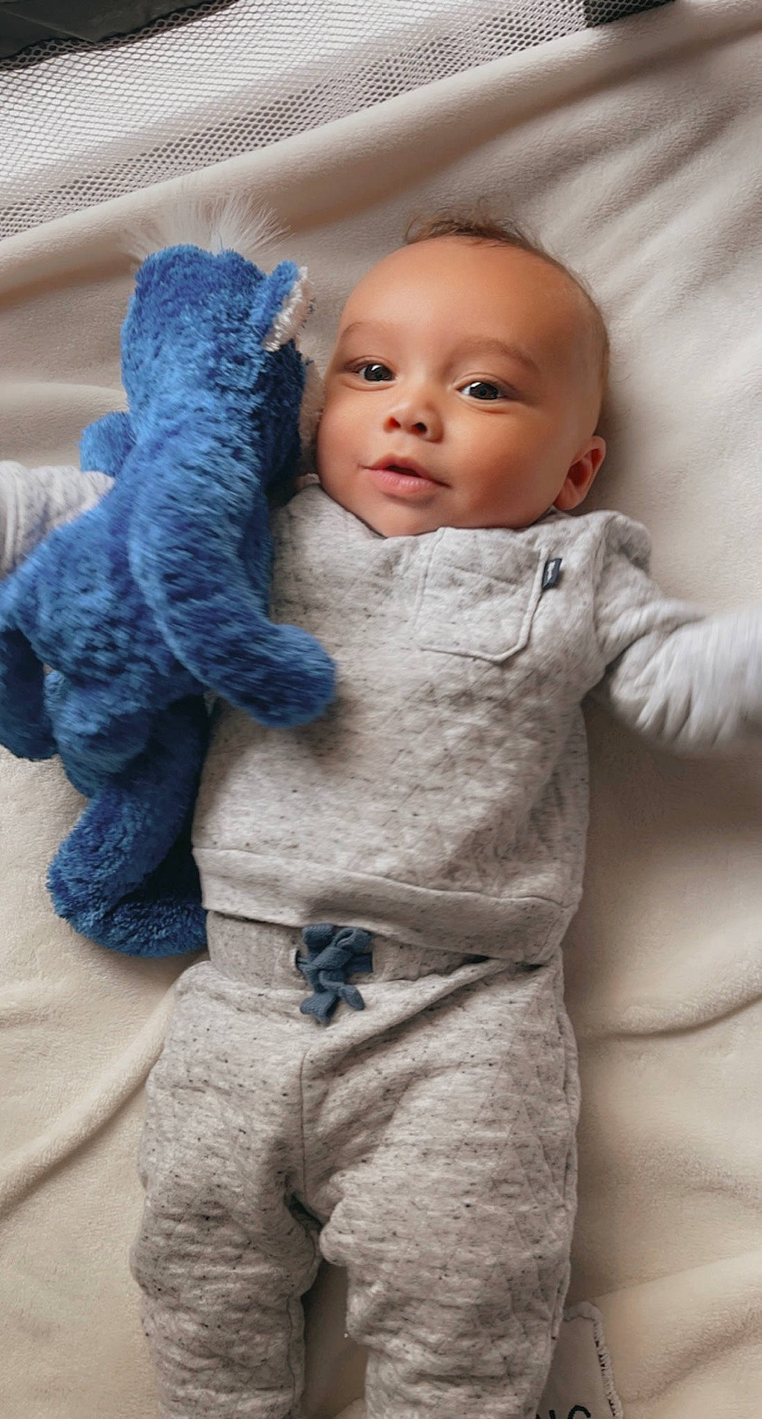 Kailer joined the competition — help win amazing prizes! baby, blue, cheek, child, doll, eye, eyelash, finger, gesture, grey, hand, head, headgear, nose, outerwear, person, skin, sleeve, textile, toy