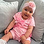 Dolcie-Rae is registered to the contest to win money with this photo: baby, bows, child, closeup, couch, cozy, cute, fabric, flower, happy, headband, indoor, infant, pillows, pink_clothing, portrait, sitting, smiling, soft_lighting, white_socks