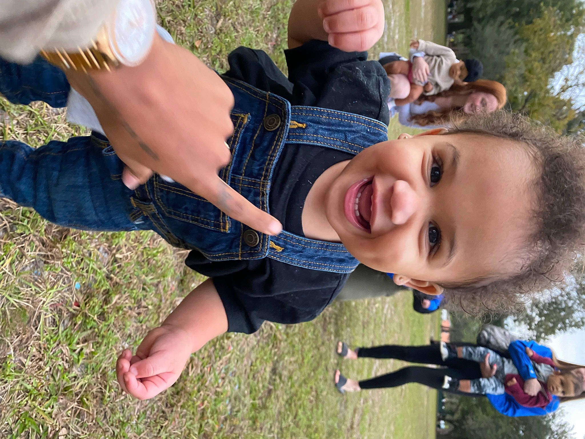 Kareem is registered to the contest to win money with this photo: arm, child, clothing, finger, fun, gesture, grass, grass_family, hand, happy, headwear, joint, joy, leisure, people_in_nature, person, plant, smile, thumb, toddler