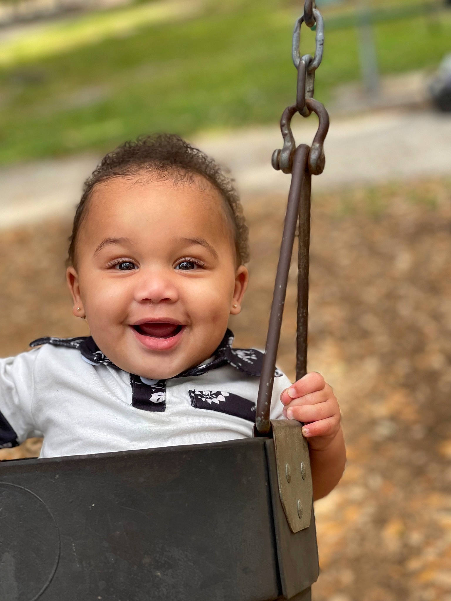 Kareem joined the competition — help win amazing prizes! baby, baby_toddler_clothing, chin, eye, fun, grass, hair, hand, happy, head, human_body, joy, leisure, nose, person, playground, recreation, smile, swing, toddler