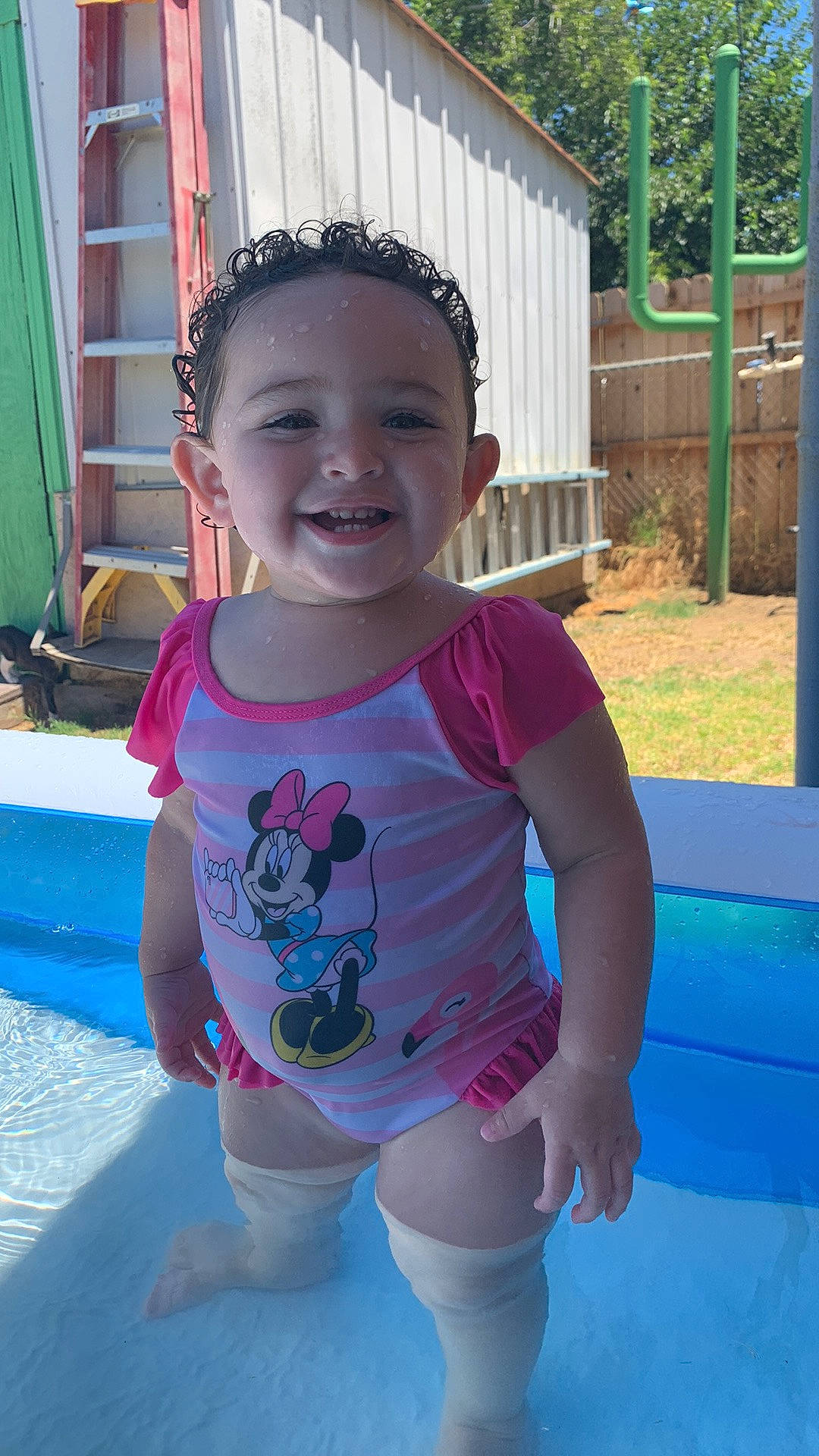 Octavia is registered to the contest to win money with this photo: azure, baby, baby_toddler_clothing, blue, face, grass, hairstyle, happy, joy, leisure, person, pink, plant, public_space, recreation, skin, sleeve, smile, summer, toddler