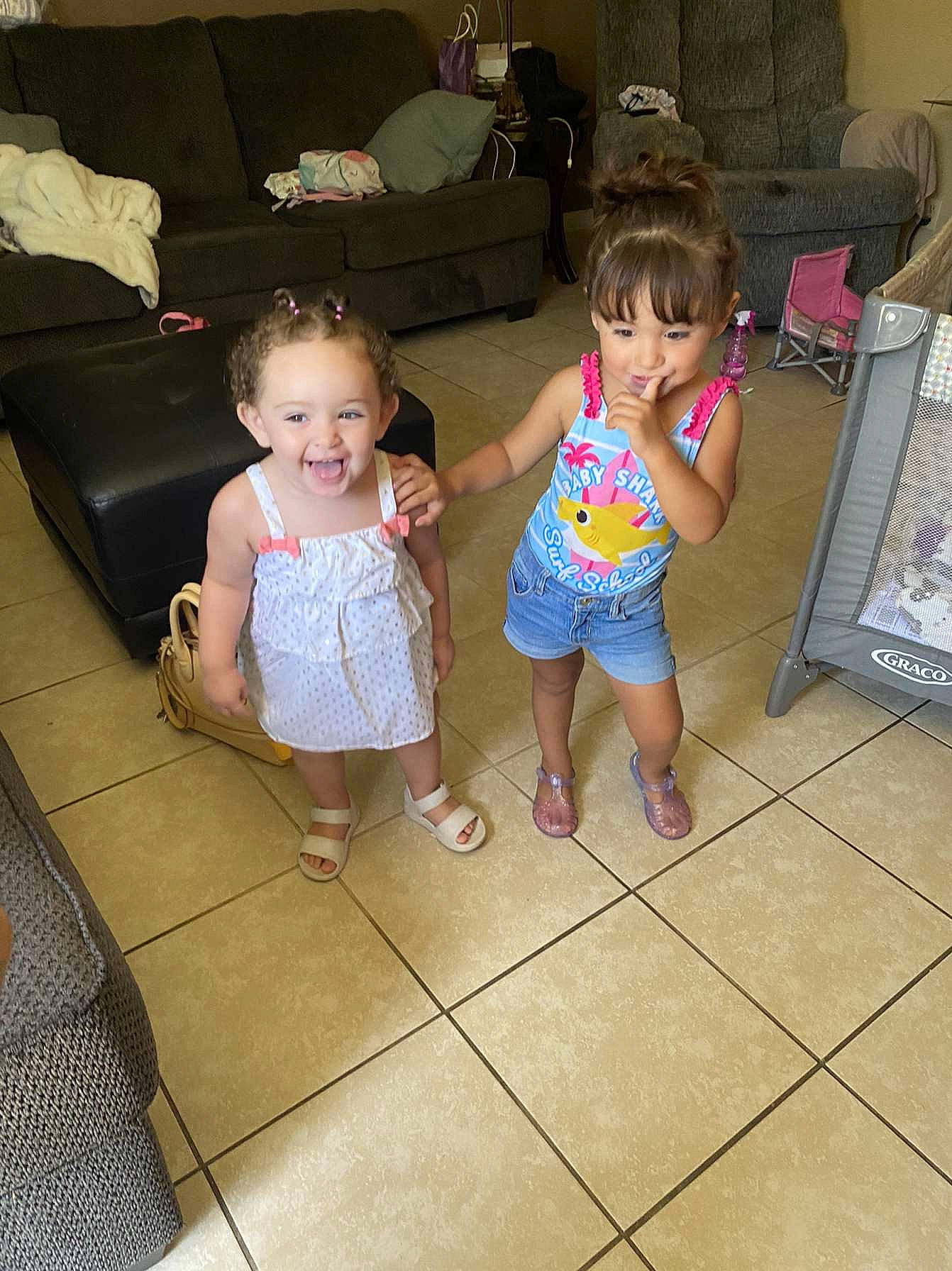 Octavia is registered to the contest to win money with this photo: baby, baby_toddler_clothing, child, comfort, couch, eye, floor, flooring, foot, fun, hair, head, joy, leisure, living_room, people, person, shorts, sitting, skin