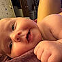 Brileigh is registered to the contest to win money with this photo: baby, infant, close_up, face, skin, hand, lying_down, indoor, expression, cute, child, newborn, portrait, person, softness, curious, playful, young, smiling, cozy