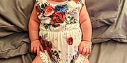 Brileigh is registered to the contest to win money with this photo: baby, infant, smile, headband, romper, floral_pattern, bed, pillow, skin, legs, arms, cute, happy, lying_down, child, indoors, fabric, soft, comfort, person