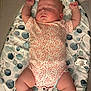 baby, sleeping, onesie, crib, mattress_pad, pacifier, infant, arms_up, sleep, child, patterned_bedding, mesh, cute, indoor, rest, peaceful, floral_print, lying_down, toddler, skin