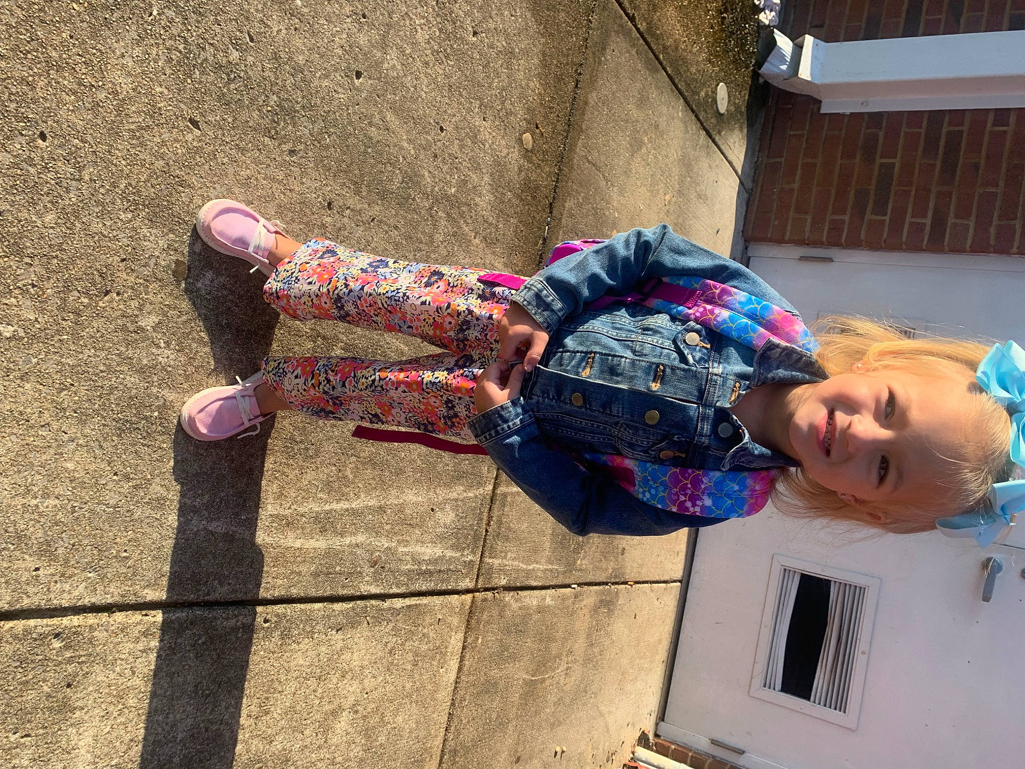 Kynlee is registered to the contest to win money with this photo: concrete, denim, electric_blue, eyewear, fashion_accessory, foot, fun, human_leg, joy, magenta, pattern, person, plaid, road_surface, shadow, sitting, t_shirt, tartan, thigh, tints_and_shades