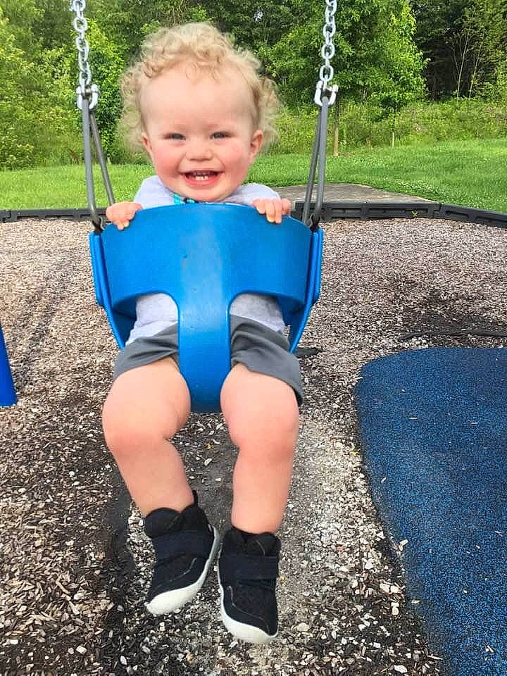 Carlos is registered to the contest to win money with this photo: asphalt, blue, child, electric_blue, eye, face, fun, grass, happy, head, human_body, joy, leg, leisure, person, plant, playground, recreation, smile, swing
