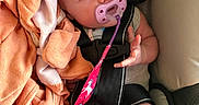 Autumn joined the competition — help win amazing prizes! baby, pacifier, car_seat, blanket, infant, child, seatbelt, cute, indoor, soft, pink, orange, clothing, person, newborn, hands, feet, safety, closeup, portrait