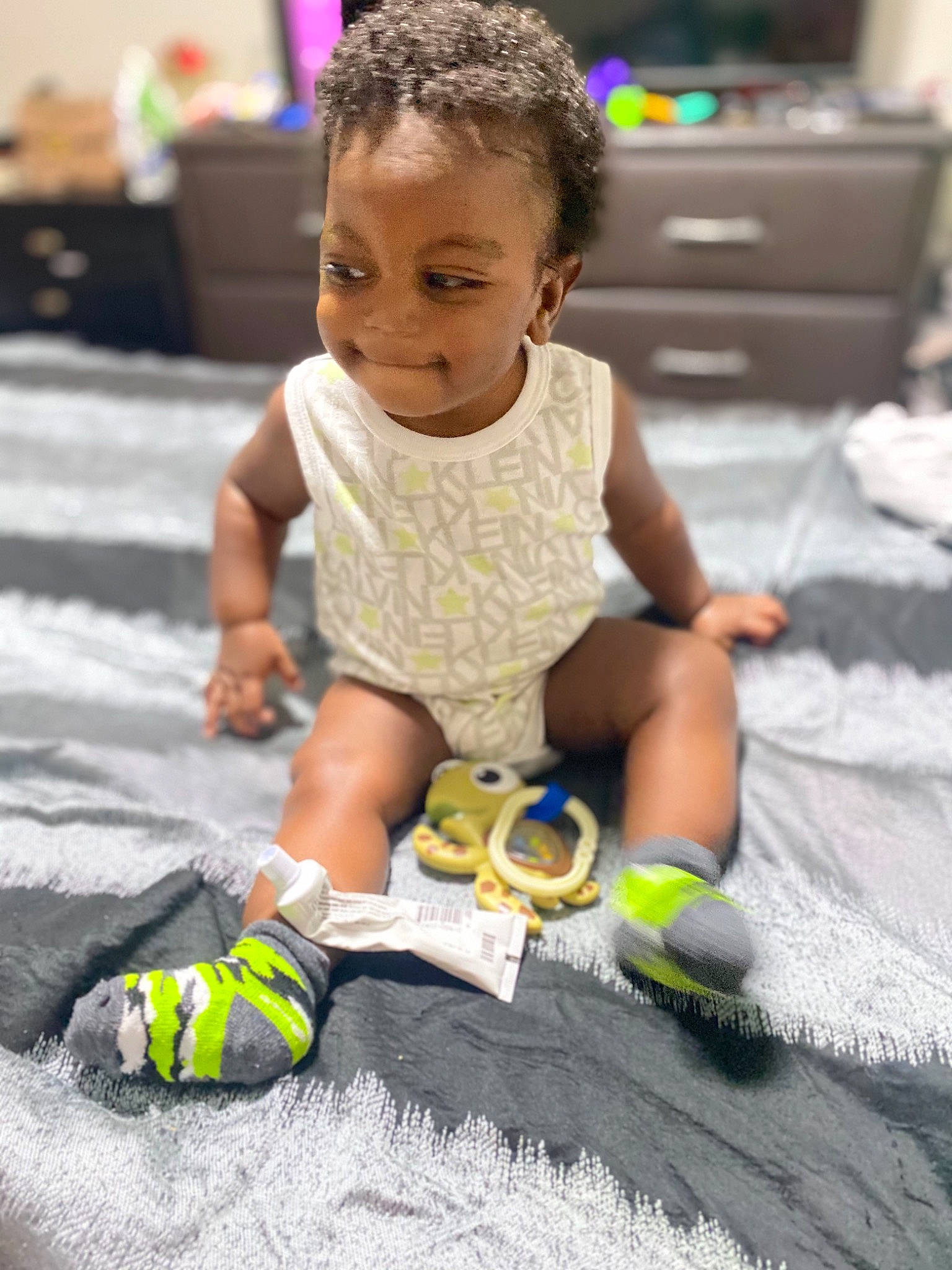 Jovãni is registered to the contest to win money with this photo: baby, baby_toddler_clothing, beauty, child, event, floor, flooring, foot, fun, green, happy, human, human_leg, leisure, person, play, product, sitting, smile, sock