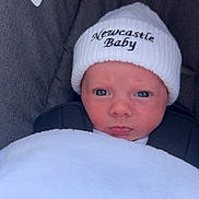 Alfie joined the competition — help win amazing prizes! baby, newborn, hat, white_blanket, car_seat, face, infant, child, cozy, cute, portrait, closeup, expression, warning_label, clothing, baby_hat, newcastle_baby, wrapped, indoor, seat