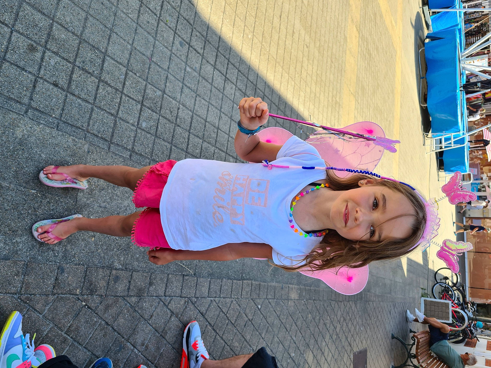 Jennifer participe au concours pour gagner de l'argent avec cette photo : child, city, cool, eyewear, footwear, fun, hat, human_leg, joy, knee, leisure, magenta, person, pink, recreation, sandal, shorts, sidewalk, thigh, tire