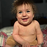 Airika joined the competition — help win amazing prizes! baby, child, smiling, happy, portrait, cute, infant, skin, hair, hands, feet, bed, blanket, plaid, indoors, person, young, expression, eyes, cheeks