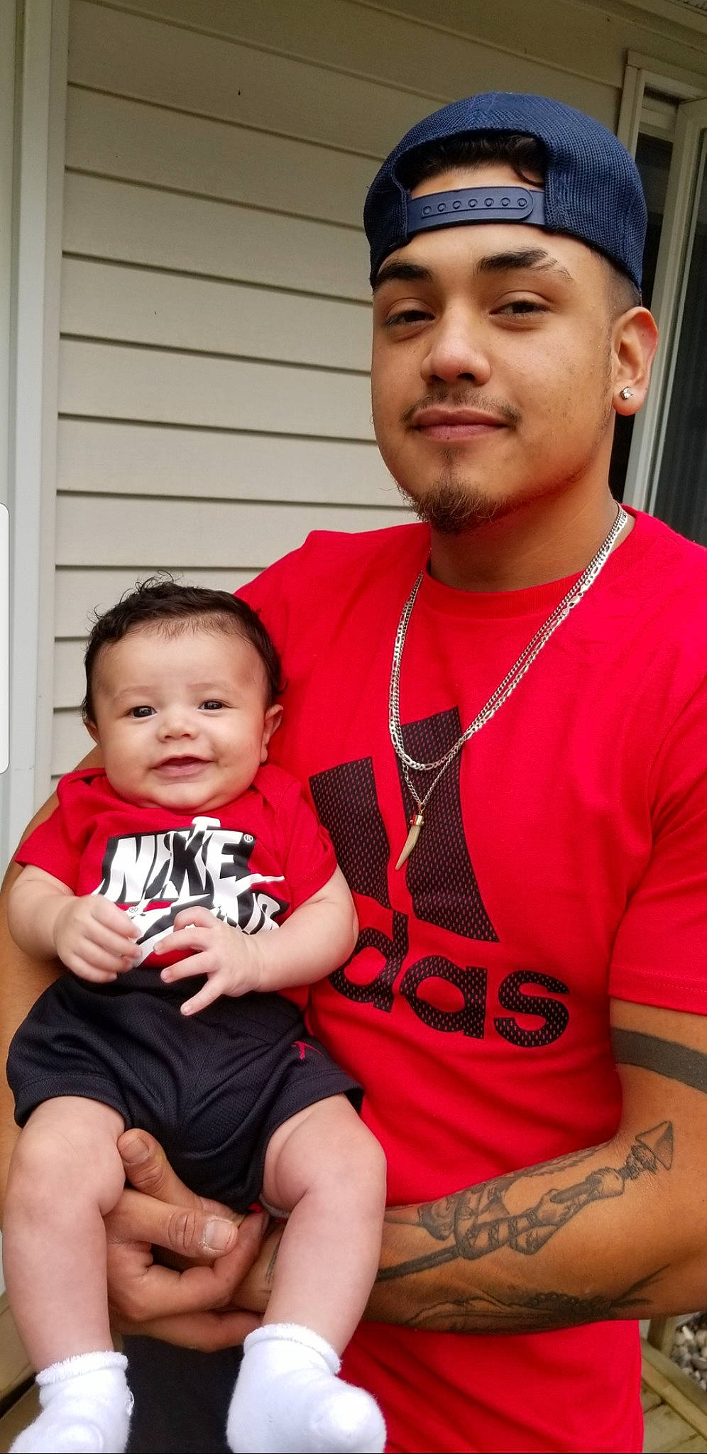 Eliazar is registered to the contest to win money with this photo: arm, baby, baby_toddler_clothing, blue, cap, child, chin, face, fun, happy, hat, headwear, joy, muscle, organ, person, red, shorts, skin, t_shirt