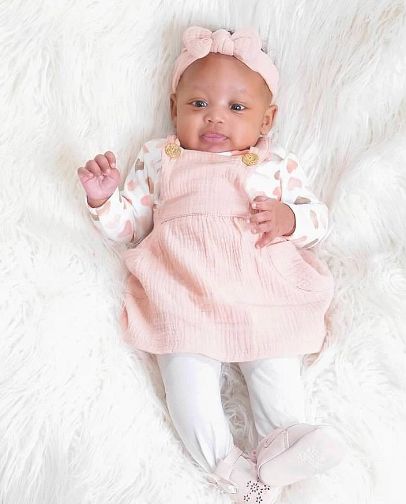 Aubreigh joined the competition — help win amazing prizes! baby, baby_toddler_clothing, cheek, day_dress, dress, embellishment, eye, face, hair_accessory, head, headgear, iris, lip, one_piece_garment, person, pink, ruffle, skin, sleeve, textile