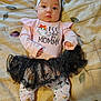 baby, infant, child, clothing, headband, tutu, black_tutu, long_sleeve_shirt, leggings, bedspread, patterned_clothes, cute, halloween_theme, lying_down, indoors, expression, face, hands, feet, soft_lighting