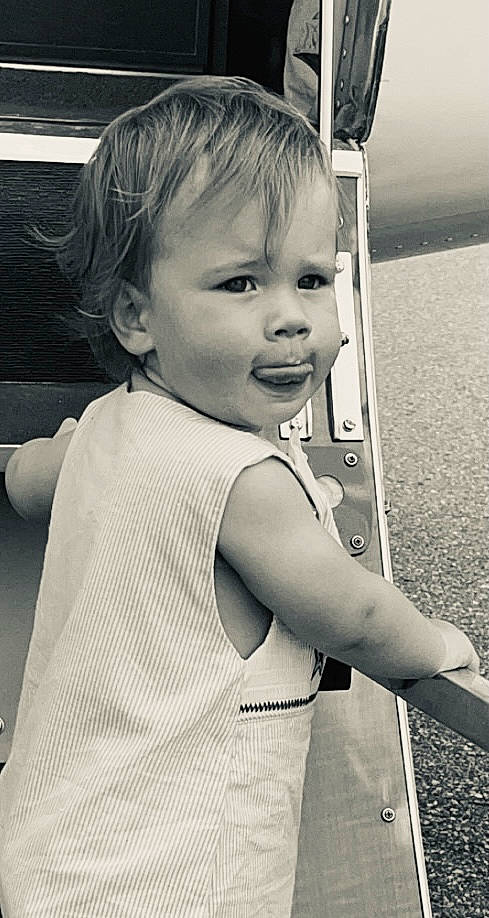 Baylor is registered to the contest to win money with this photo: baby_toddler_clothing, black_and_white, child, cool, eye, facial_expression, flash_photography, gesture, hair, hand, happy, human, human_body, iris, person, sky, sleeve, smile, standing, style