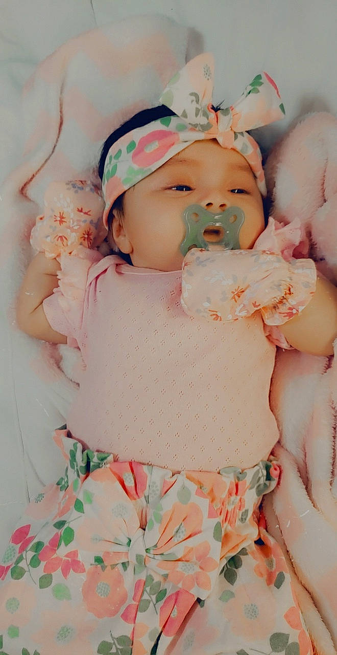 Leah is registered to the contest to win money with this photo: arm, baby, baby_sleeping, baby_toddler_clothing, beauty, cheek, child, eye, eyelash, finger, happy, headband, headgear, headpiece, lip, pattern, person, pink, skin, toddler