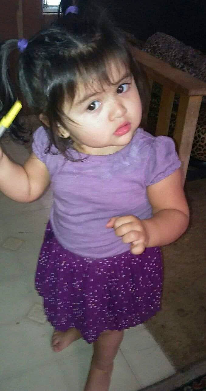 Kyla is registered to the contest to win money with this photo: arm, baby_toddler_clothing, cheek, chin, clothing, eyelash, face, facial_expression, hair, hairstyle, head, iris, joint, lip, neck, nose, organ, person, purple, skin