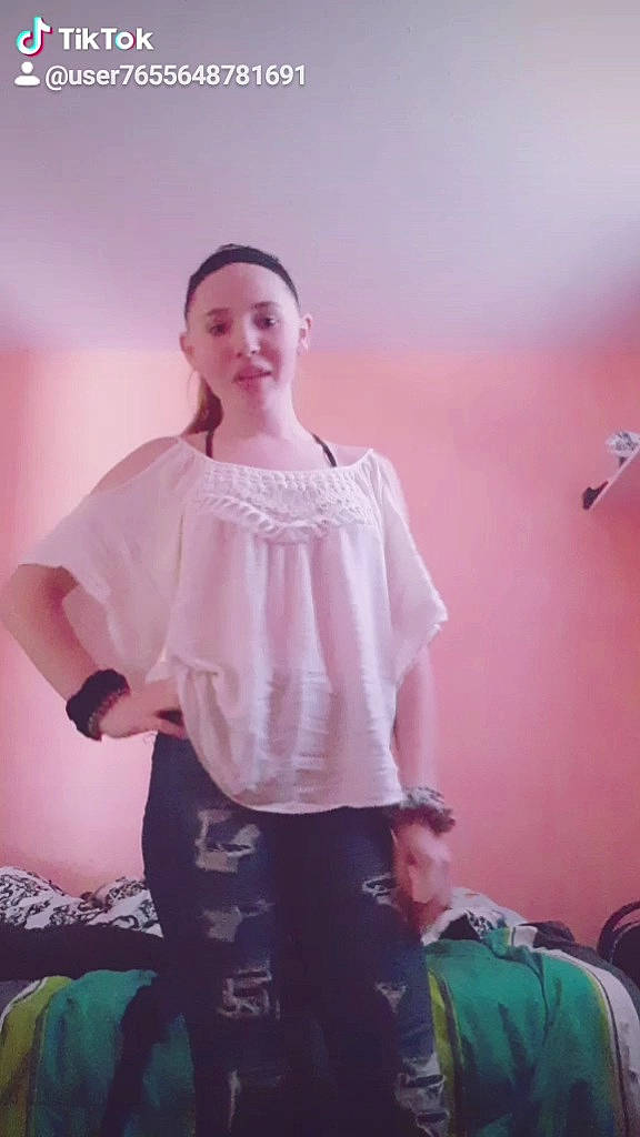 Joslynn is registered to the contest to win money with this photo: blouse, clothing, dress, fashion_accessory, gesture, joint, neck, peach, person, pink, shirt, shoulder, sitting, sleeve, t_shirt, textile, top, white