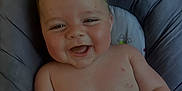Alessio participe au concours pour gagner de l'argent avec cette photo : baby, laughing, smiling, infant, child, cushion, seat, indoor, skin, face, happy, chubby, arm, torso, comfortable, cute, person, young, head, expression