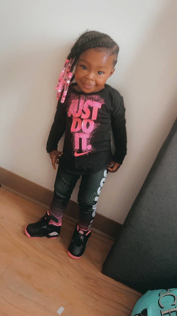 Kaniyah joined the competition — help win amazing prizes! baby_toddler_clothing, black_hair, child, face, hair, head, joint, joy, knee, leg, magenta, person, shoulder, skin, sleeve, sock, sportswear, t_shirt, thigh, toddler