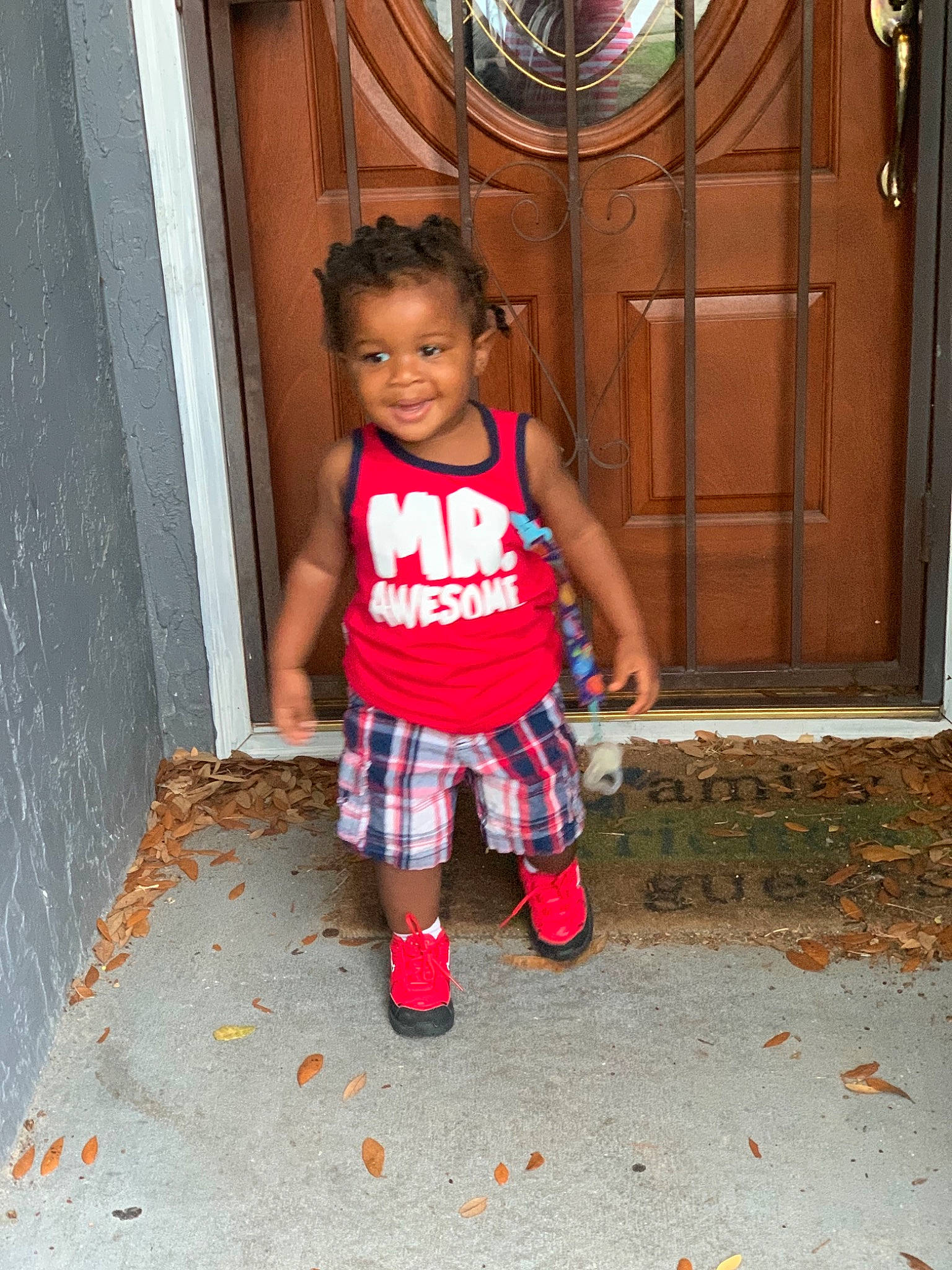 Braiden is registered to the contest to win money with this photo: child, design, footwear, fun, joy, pattern, person, pink, plaid, play, shoe, smile, standing, toddler