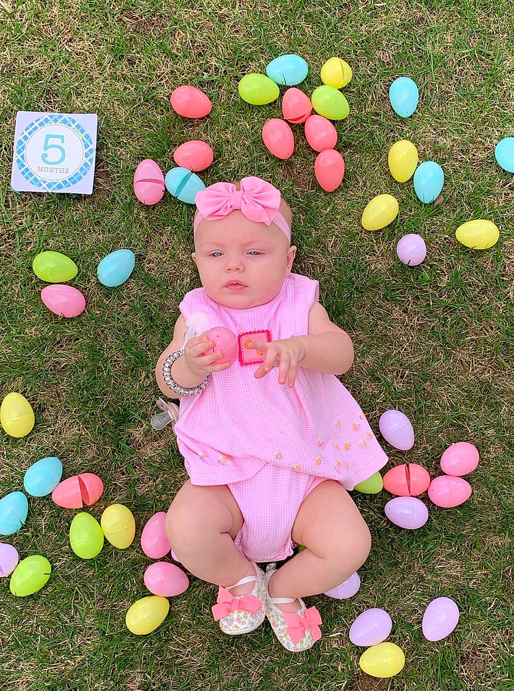 Diezel is registered to the contest to win money with this photo: balloon, child, easter, easter_egg, egg, grass, holiday, party_supply, person, pink, play, toddler