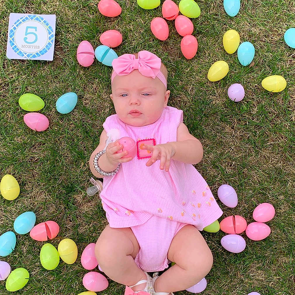 Diezel is registered to the contest to win money with this photo: balloon, child, easter, easter_egg, egg, grass, holiday, party_supply, person, pink, play, toddler