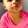 child, toddler, pink_shirt, face, portrait, indoor, curious, looking_up, young_child, expression, closeup, person, cute, innocent, soft_light, head, eyes, skin, hair, casual_clothing