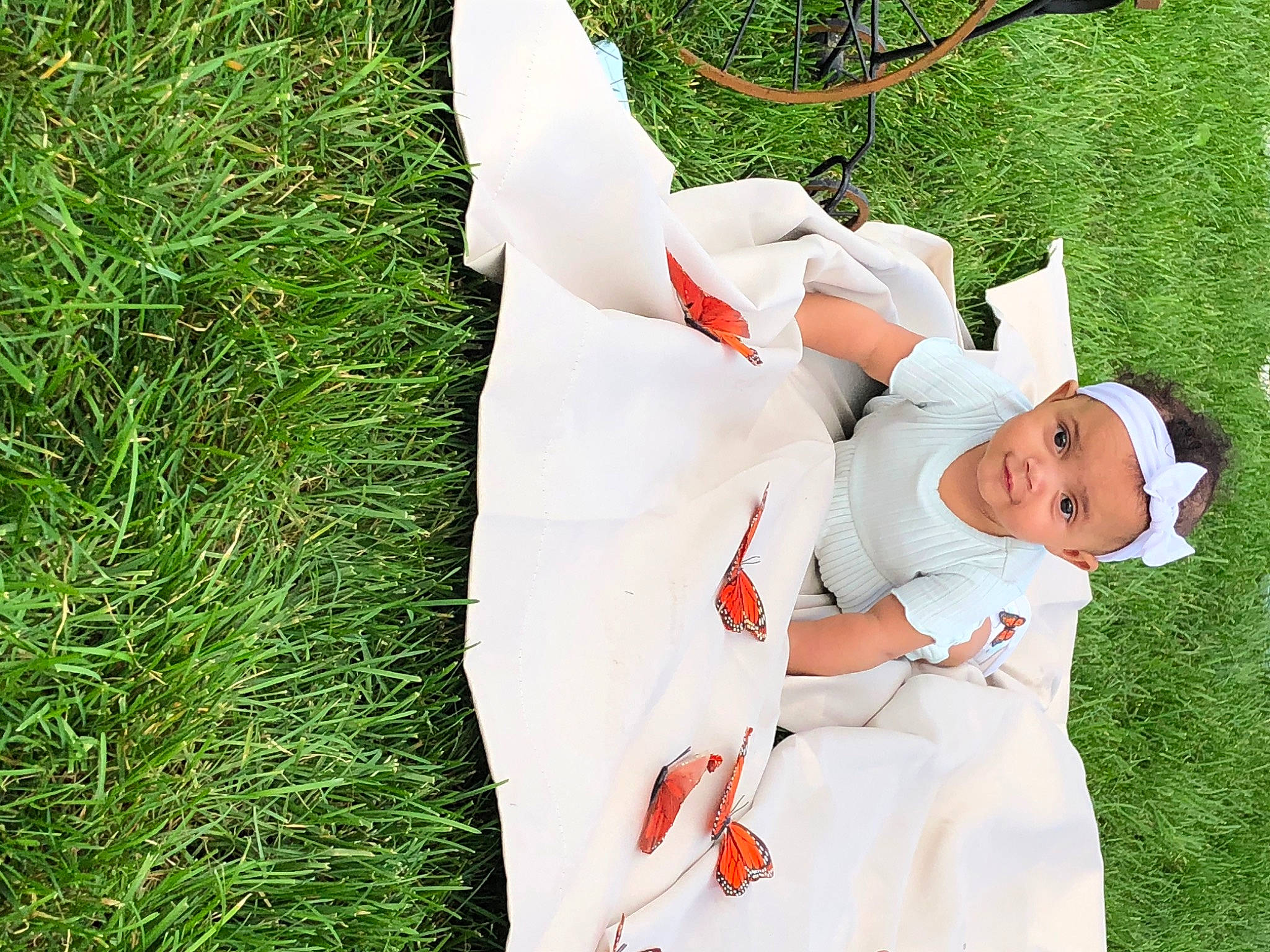 Vera is registered to the contest to win money with this photo: baby, baby_toddler_clothing, child, dress, event, fictional_character, fun, gesture, grass, grassland, happy, hat, headwear, holiday, human_body, leg, leisure, people_in_nature, person, plant