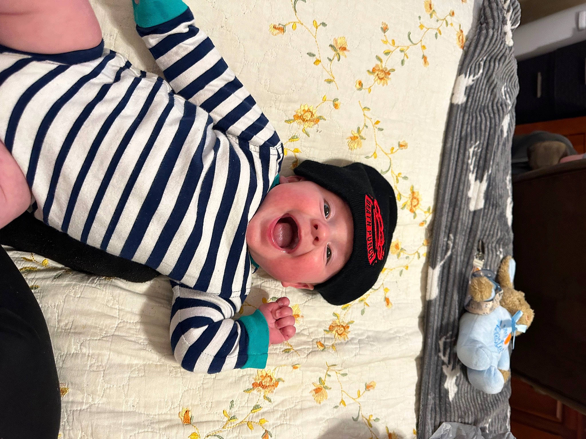 Colton is registered to the contest to win money with this photo: baby, baby_products, baby_toddler_clothing, child, comfort, fun, happy, hat, headwear, leisure, linens, pattern, person, portrait_photography, room, sitting, sleeve, sun_hat, toddler, tree
