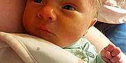 Evelynn is registered to the contest to win money with this photo: baby, infant, blanket, clothing, face, hand, fist, skin, person, newborn, cute, soft, warm, indoors, closeup, sleepwear, expression, child, resting, comfort