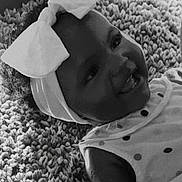 Marcia joined the competition — help win amazing prizes! baby, black_and_white, blanket, bow, child, closeup, clothing, cute, face, happy, headband, indoors, infant, person, polka_dot, portrait, smiling, texture, toddler, young