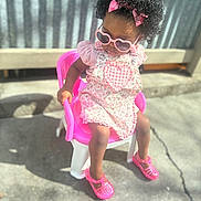 Love joined the competition — help win amazing prizes! toddler, child, sunglasses, pink, dress, bow, curly_hair, chair, outdoor, shoes, sunlight, plastic_chair, fashion, cute, portrait, person, summer, shadow, concrete, accessory