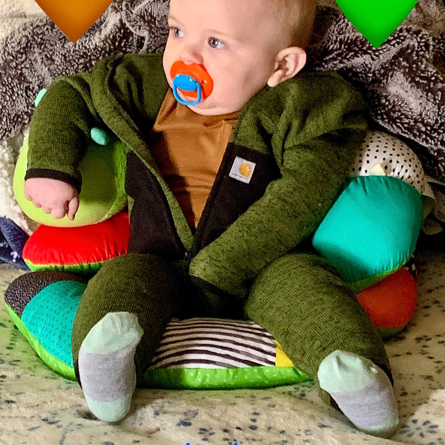 Daker is registered to the contest to win money with this photo: baby, clothing, coat, couch, cushion, face, furniture, happy, head, homedecor, hosiery, jacket, pants, person, photography, portrait, sitting, sock, symbol, yawning